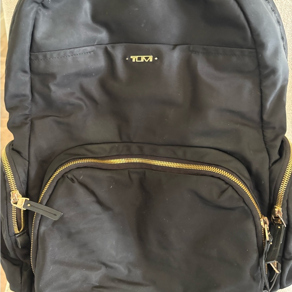 Tumi Black Backpack with Adjustable Straps and Gold Hardware